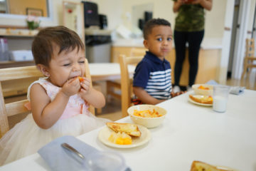 toddler having her food at our daycare center