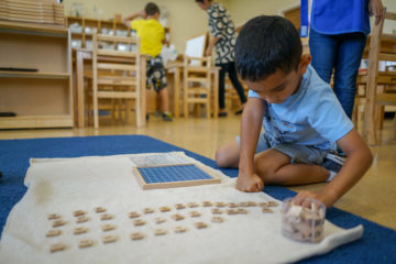 kid playing word game in our montessori school